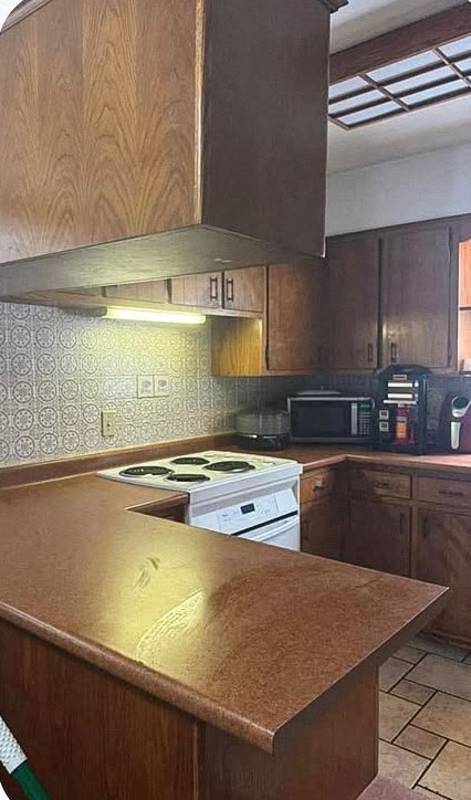 A kitchen with clear counters and a clean stove after a deep clean
